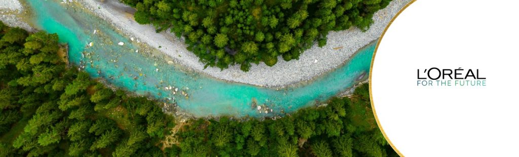 Image of river between lush landscape, Loreal for the future branding featured to the side